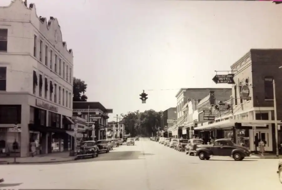 Historic photograph: 100 S. Woodland Boulevard corner entrance and storefront signs